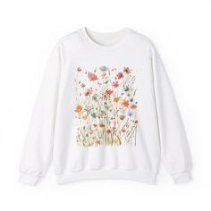 Boho Wildflower Sweatshirt, Wildflowers Cottagecore Sweatshirt, Boho Wildflower Sweater, Floral Botanical Sweatshirt Women, Flower Lover Gift, Garden Lover Gift ❤ Gildan Brand Sweatshirts & Unisex Adult Sizing Our Unisex Heavy Blend Crewneck Sweatshirt is all about cozy comfort and effortless style. Made from a lovely blend of polyester and cotton, it keeps your favorite designs looking fresh and beautiful. The absence of itchy side seams means you'll stay cozy and irritation-free. Perfect for layering or wearing on its own, this sweatshirt is your go-to for a relaxed, feminine touch. ❤ Please note that the rolled sleeves in our photos are for styling inspiration only, and any props shown are not included with your purchase. ❤ PRINT Our sweatshirts are printed using Direct-To-Garment techn Wildflower Sweatshirt, Cottagecore Sweatshirt, Brand Sweatshirts, Boho Wildflower, Garden Lover Gifts, Women Flower, Styling Inspiration, Rolled Sleeves, Sweatshirt Women