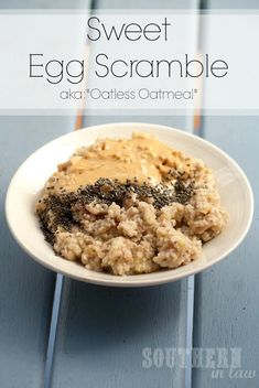 a white plate topped with oatmeal next to a fork and spoon on top of a blue table