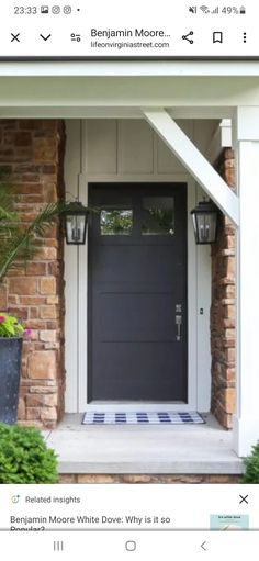 an image of a black front door with white trim and brickwork on the side