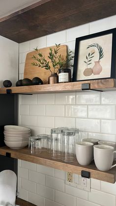 the shelves in the kitchen are filled with dishes and cups, along with other items