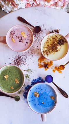 four bowls filled with different colored food on top of a table