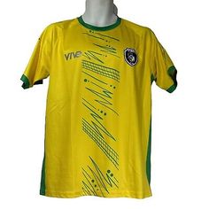 a yellow and green soccer jersey on a mannequin's head with an emblem