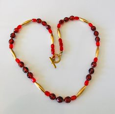 This light weight variegated faceted clear red and gold bead necklace is 20 inches long. The widest bead is 8mm and the long gold beads are 3/4 inches long. The bead is bright and light. It has a bar and loop clasp. I specialize in finding fun wearable vintage jewelry. Please browse my shop for more options. I have a large necklace section in my shop. I box my sales ready for gift giving. Gold Faceted Beaded Necklaces For Gifts, Gold Faceted Bead Necklaces For Gifts, Gold Faceted Beads Necklace For Gift, Gift Gold Faceted Beaded Necklaces, Faceted Czech Glass Beaded Necklaces As Gift, Gold Beaded Necklaces With Faceted Round Beads, Gold Beaded Necklace With Faceted Czech Glass Beads, Red Faceted Beads Necklace For Celebration, Gold Czech Glass Beaded Necklaces With Faceted Beads