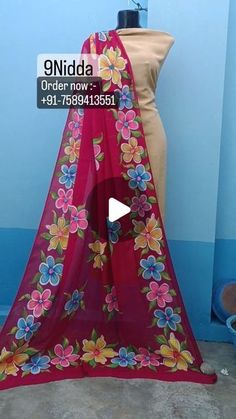 a mannequin wearing a pink sari with flowers on it