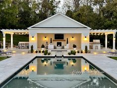 a pool with lights around it and an outdoor living area in the back ground is lit up