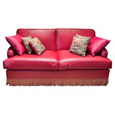 a red leather couch with two pillows on it's back and one arm folded down