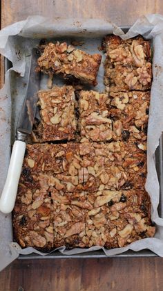 a pan filled with granola bars on top of a wooden table