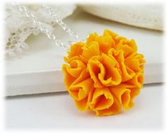 Petite hand sculpted 2cm marigold necklace on a hand wired bail. -Original hand sculpted polymer clay flowers -Durable, water-resistant -No molds, no paint, no glue -Flower Size : 2cm (about 3/4 inch) -16 inch or 18 inch chain -Silver-plated, Gold-plated, Antique Brass, 925 sterling Silver or 14k Gold Filled View matching collection at: https://www.etsy.com/shop/strandedtreasures/search?search_query=marigold Flowers are hand sculpted without molds or paint using polymer clay, a durable water-res Gold Polymer Clay Jewelry With 3d Flowers, Gold Jewelry With 3d Flowers In Polymer Clay, Gold Flower Jewelry In Polymer Clay, Gold Flower-shaped Polymer Clay Jewelry, Gold Flower Polymer Clay Jewelry, Gold Polymer Clay Flower Jewelry, Handmade Yellow Flower Pendant Necklace, Unique Orange Flower Shaped Jewelry, Unique Orange Flower-shaped Jewelry