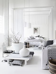 a white bedroom with black and white decor