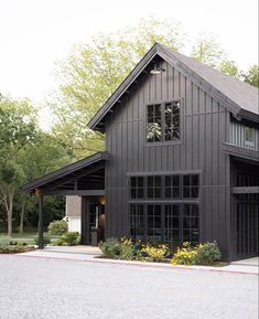 a black house with lots of windows on the front and side of it's roof