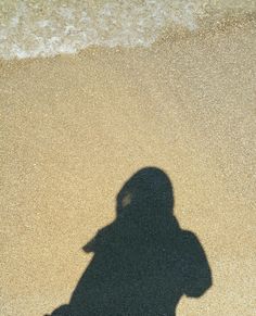 a shadow of a person on the beach