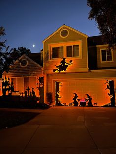 a house decorated for halloween with pumpkins and witches