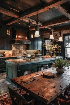 a large kitchen with an island and wooden table in the center, surrounded by chairs