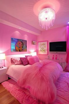 a pink bedroom with chandelier and bed