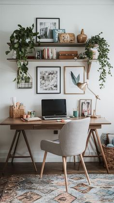 a desk with a laptop on it in front of a wall full of pictures and plants