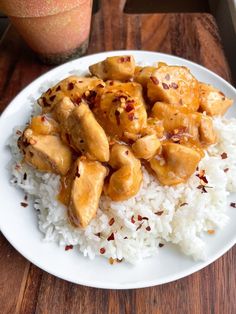 a white plate topped with rice and chicken