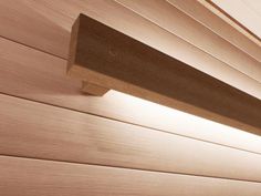 a close up view of a wooden beam on the side of a building with wood slats