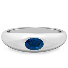 a white gold ring with a blue sapphire stone in the center, on a white background