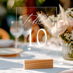 the table numbers are displayed on a clear acrylic sign that says table 10