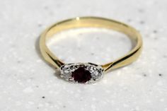 18ct Yellow gold diamond and ruby 3 stone ring that really sparkles in the light hallmarked London 750 (18ct) weights 2.5 grams size UK S  US 91/2 In very good condition no comes in a grey velvet presentation box. Classic Gold Ruby Ring With Three Stones, Classic Three-stone Ruby Ring For Formal Occasions, Classic Three Stone Ruby Ring For Formal Occasions, Gold Ruby Three-stone Ring For Formal Events, Gold Ruby Three Stone Ring For Formal Events, Gold Three Stone Ruby Ring For Formal Occasions, Formal Gold Ruby Ring With Three Stones, Formal Three Stone Ruby Ring, Extravagant Dresses