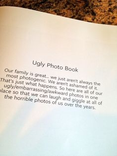 an open photo book on a table with writing in the middle and bottom pages that read,'ugly photo book our family is great, we just aren't always the