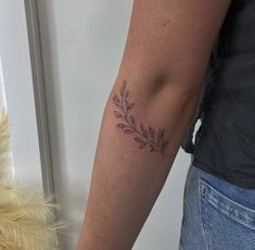 a woman with a tattoo on her arm