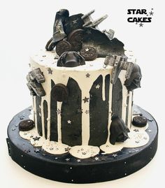 a star wars themed cake with white frosting and oreo cookies on the top