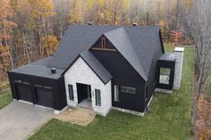 an aerial view of a house in the fall with lots of leaves on the trees