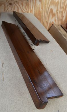 two pieces of wood sitting on top of a table