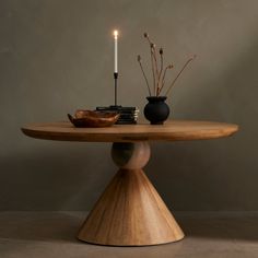 a wooden table with two candles on it