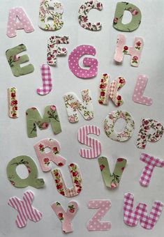 the letters and numbers are made out of fabric flowers, polka dots, and stripes