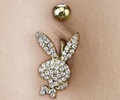 a gold rabbit brooch with diamonds on it