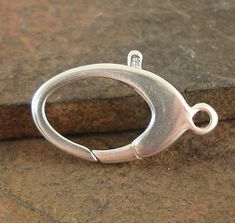 a silver ring sitting on top of a rock