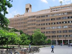 several bicycles are parked in front of a large building