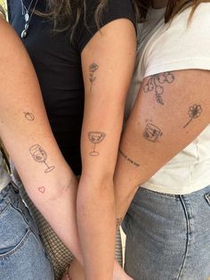 two women with matching tattoos on their arms