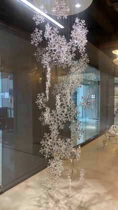 a glass sculpture with snowflakes hanging from it's sides