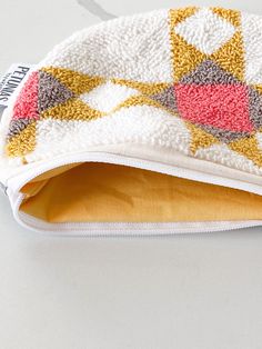 a close up of a towel on a table with an object in the back ground