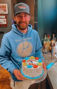 a man holding a cake in his hands