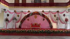 the stage is decorated with flowers and decorations