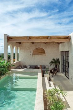 an outdoor patio with a pool and seating area