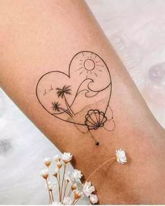 a woman's arm with a tattoo on it that has a heart and palm trees