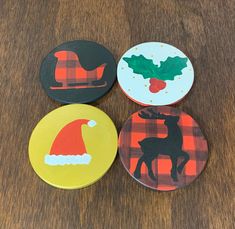 four christmas coasters are sitting on a table