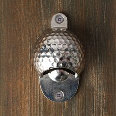 a close up of a metal object on a wooden surface