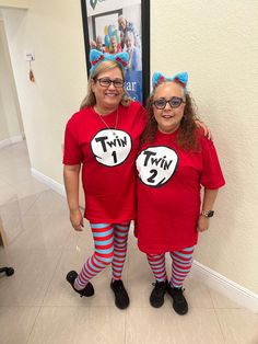 two women in red shirts and cat in the hat costumes standing next to each other