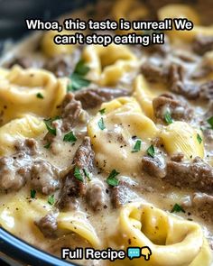 a close up of a plate of food with pasta and meat in sauce on it