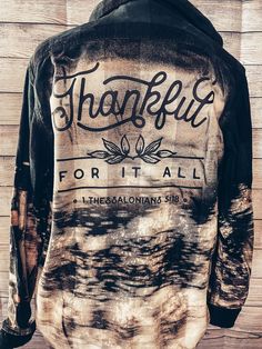 the back of a black and white tie dye jacket that says, thank for it all