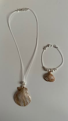 two necklaces with seashell charms attached to them