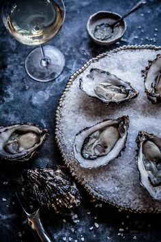 oysters on ice with wine glasses and silverware