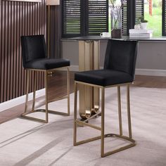 two black and gold barstools in front of a window