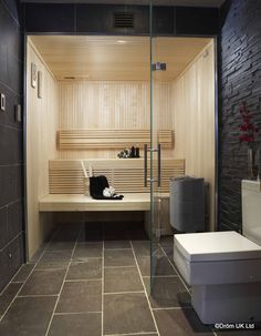 a bathroom with a wooden bench and tiled floor